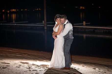 A bride and groom embracing in the dark.