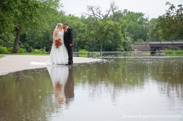 A bride and groom kissing in the water