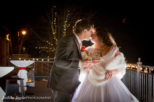 A man and woman kissing on the cheek.
