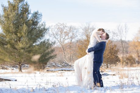A man and woman kissing in the snow.