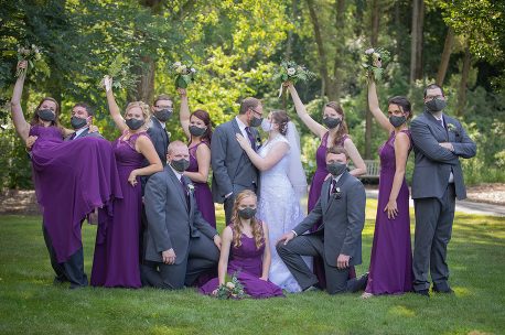 A group of people in purple and grey dresses