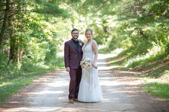 A man and woman standing on the side of a road.