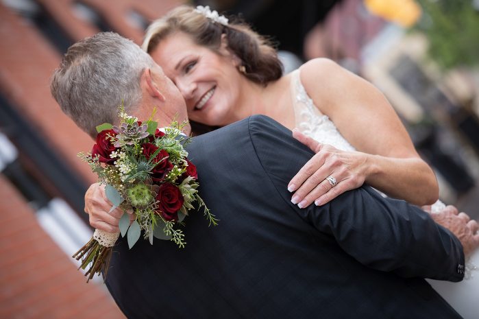 A bride and groom embracing each other at their wedding.