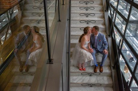 A couple sitting on the stairs kissing