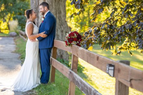 A bride and groom standing next to each other.