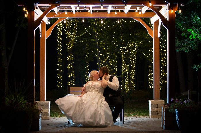 A bride and groom kissing under the gazebo.