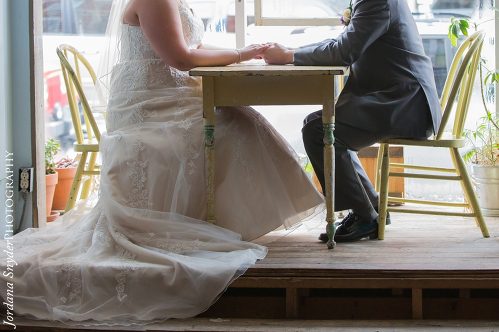 A bride and groom sitting at the table