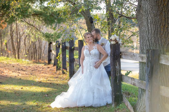 A bride and groom posing for a picture.