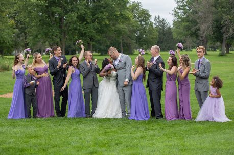 A group of people standing in the grass.