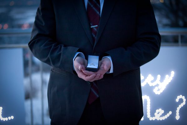 A man in a suit holding something in his hands.