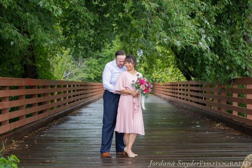 A man and woman standing on the bridge