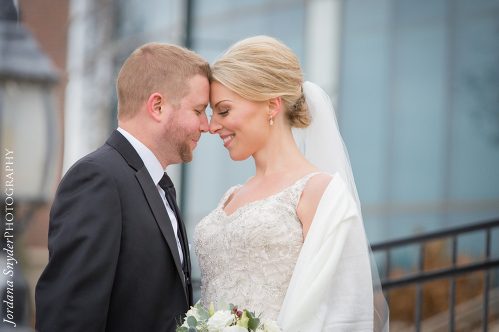 A man and woman are smiling at each other.