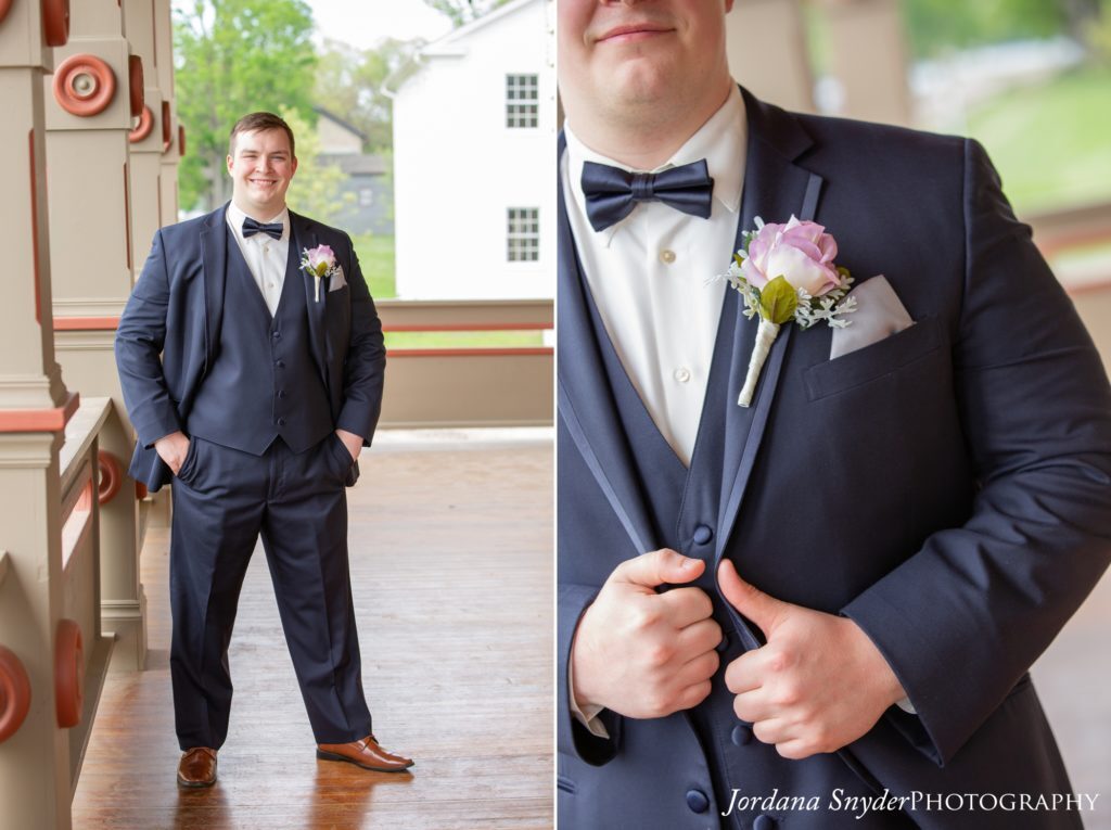 A man in a suit holding something in his hands.