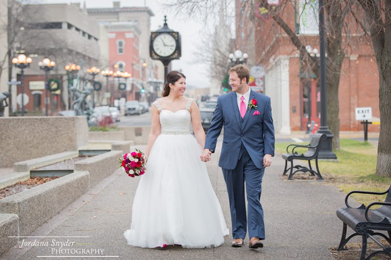 A bride and groom walking down the street