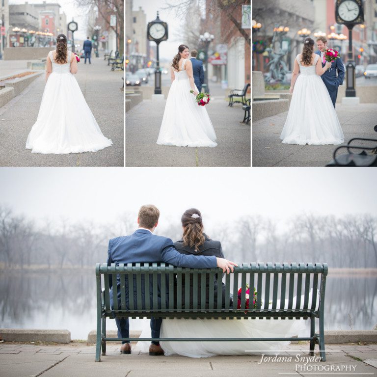 A couple sitting on top of a bench in front of a lake.