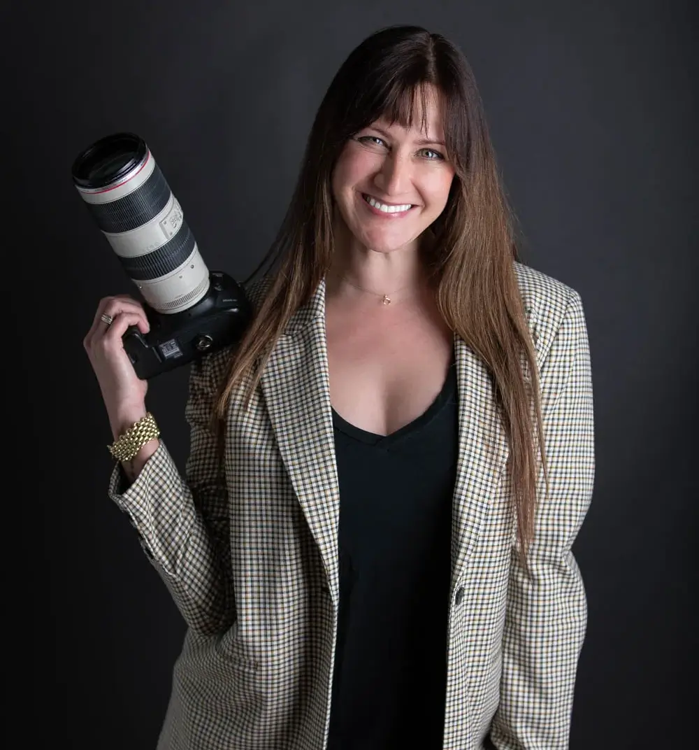 A woman holding a camera in her hand.