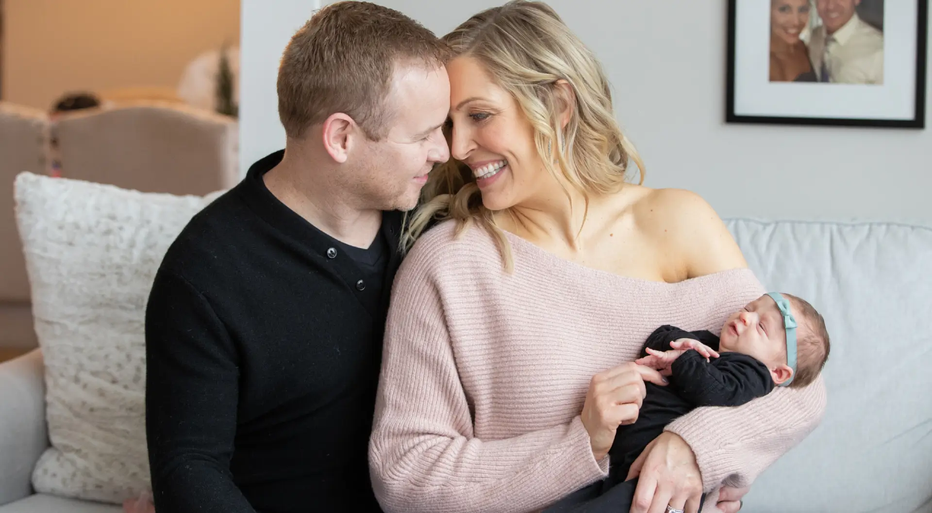 A man and woman sitting on the couch together.