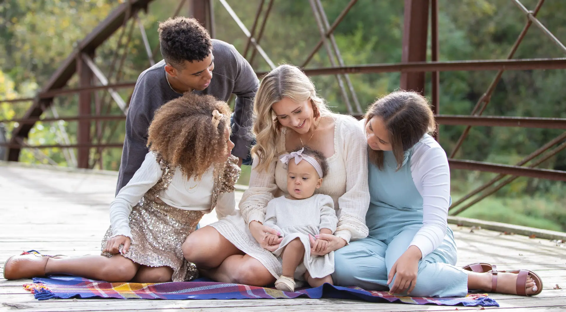 A group of people sitting around each other.