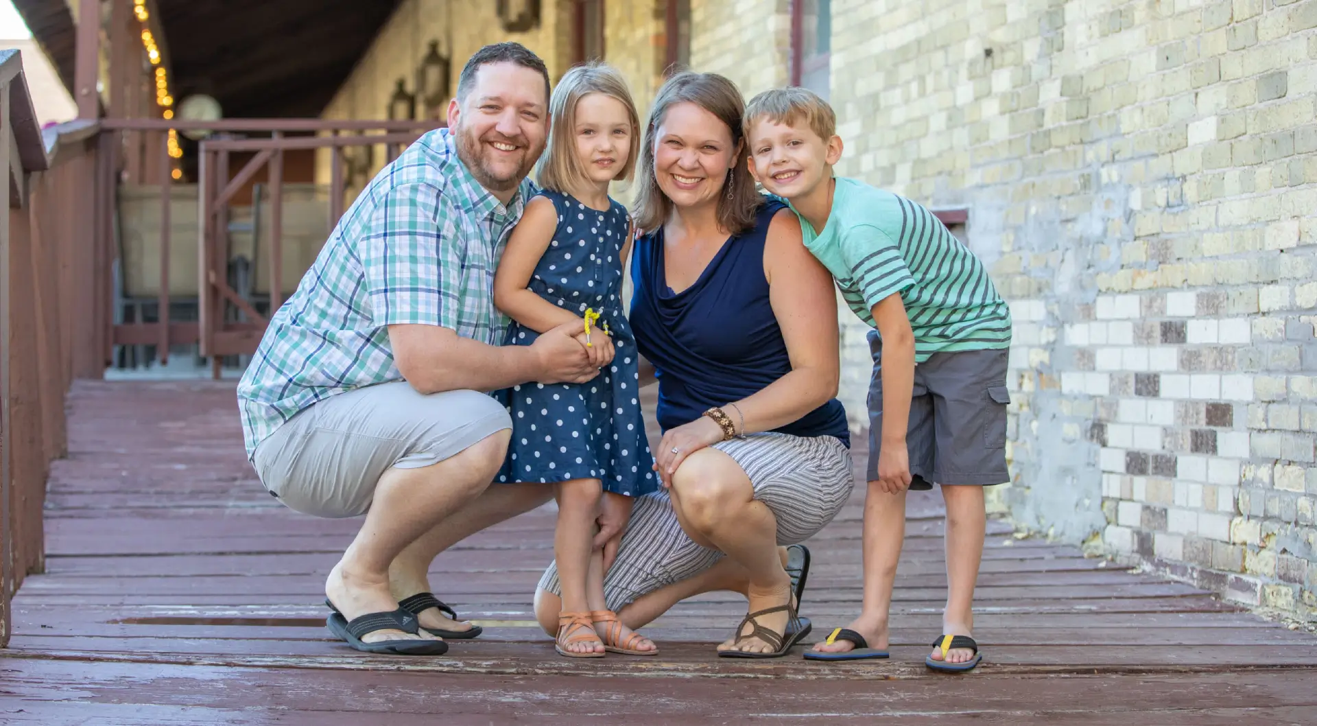A family posing for the camera on a deck.