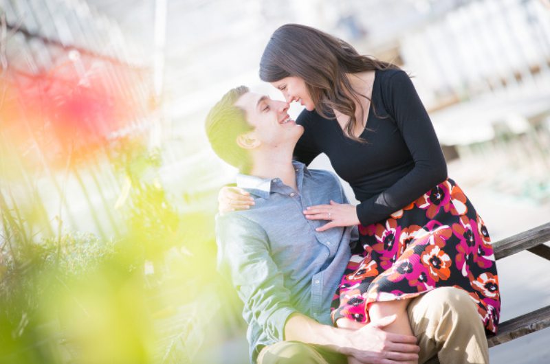 A man and woman are kissing on the cheek.
