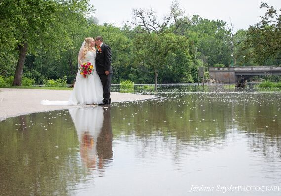 A bride and groom kissing in the water