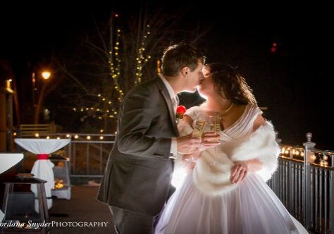 A man and woman kissing on the cheek.
