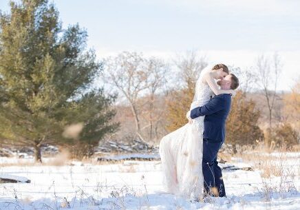 A man and woman kissing in the snow.