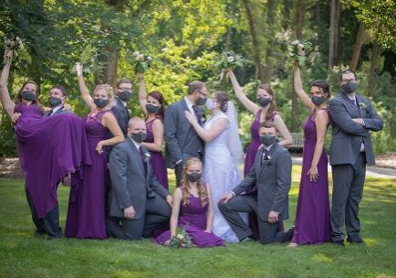 A group of people in purple and grey dresses