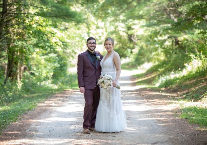A man and woman standing on the side of a road.