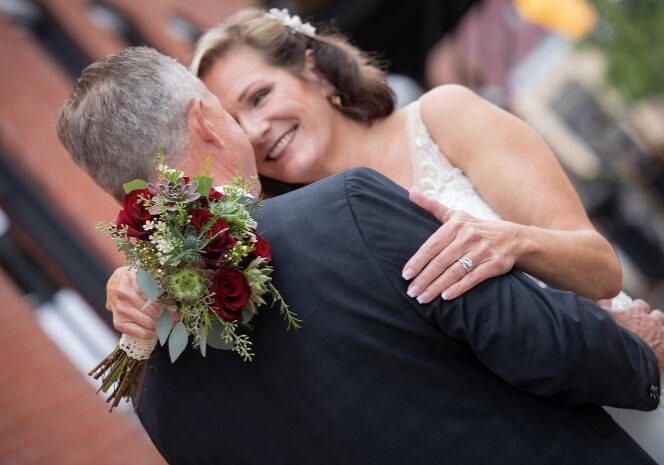 A bride and groom embracing each other at their wedding.
