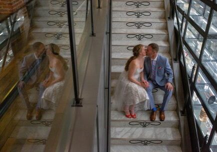 A couple sitting on the stairs kissing