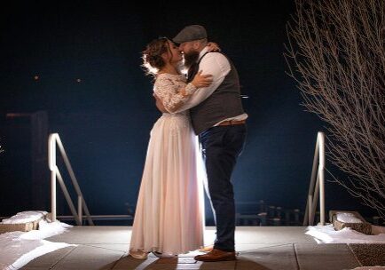 A man and woman are dancing on stage.