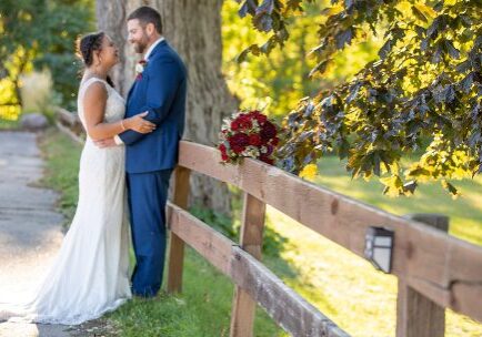 A bride and groom standing next to each other.