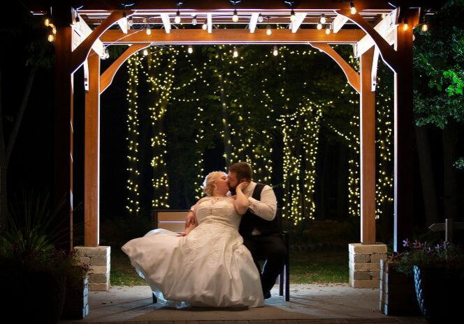A bride and groom kissing under the gazebo.