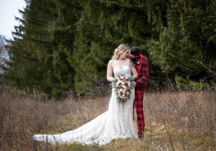 A man and woman in wedding attire standing next to each other.
