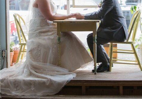 A bride and groom sitting at the table