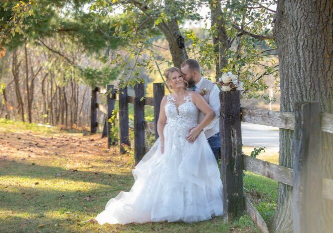 A bride and groom posing for a picture.
