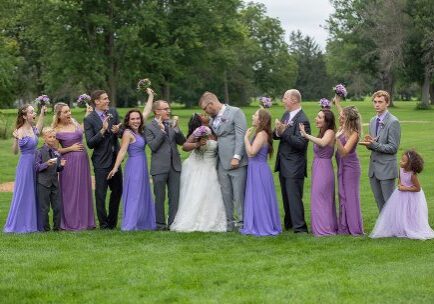 A group of people standing in the grass.