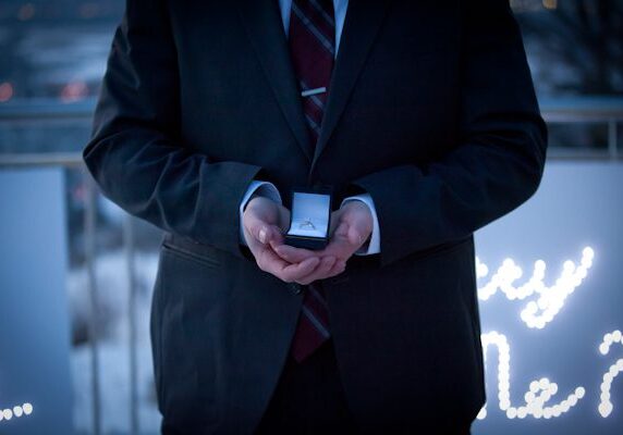 A man in a suit holding something in his hands.