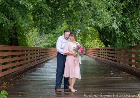 A man and woman standing on the bridge