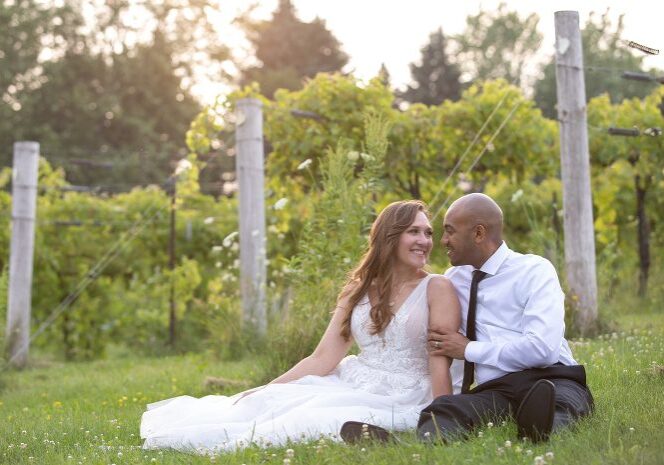 A man and woman sitting in the grass