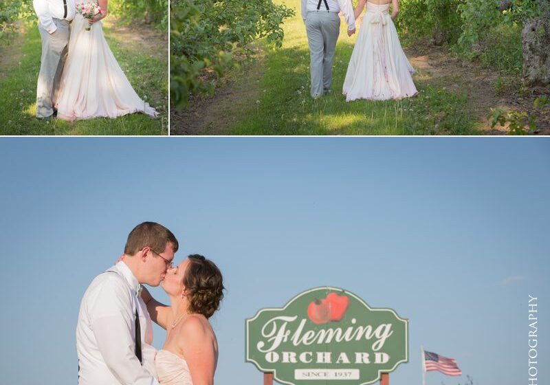 A couple kissing in front of the fleming bakery sign.