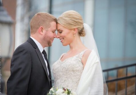 A man and woman are smiling at each other.